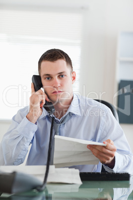 Close up of businessman calling the author of a letter