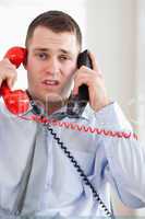 Close up of businessman troubled by the telephone