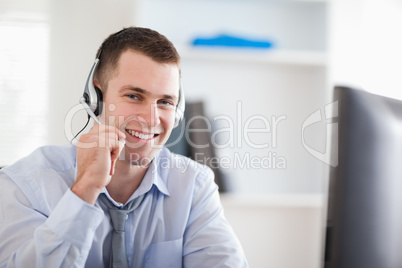 Smiling call center agent speaking with costumer