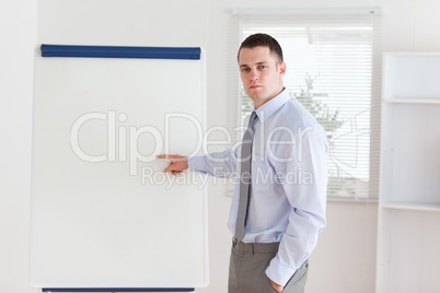 Businessman pointing at flip chart