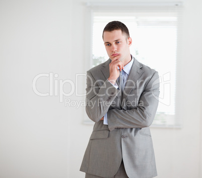 Standing businessman considering