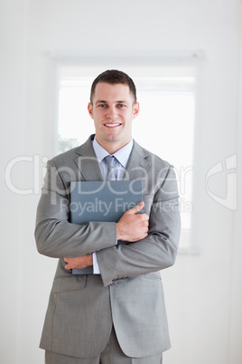 Businessman keeping his folder close