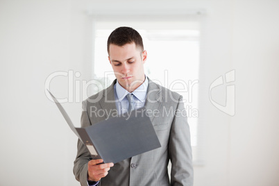 Businessman reading in his folder