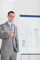 Businessman giving thumb up next to column graph