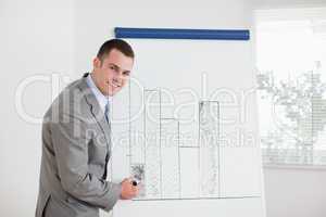 Smiling businessman editing column graph