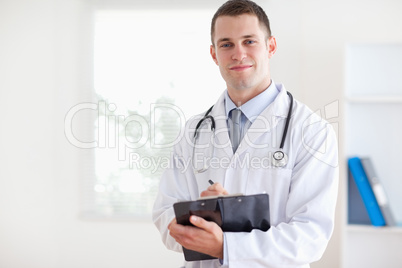 Young doctor taking notes