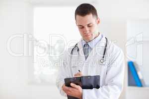 Doctor reading his notes