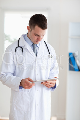 Doctor having a look at his tablet