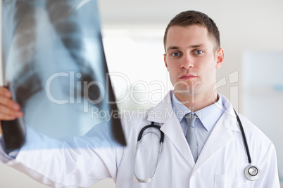 Serious looking doctor with x-ray