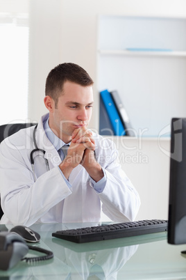 Doctor looking at computer screen