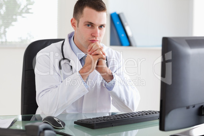 Doctor sitting behind his desk