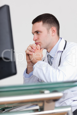 Close up of doctor reading something on his screen