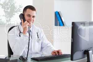 Smiling doctor on the telephone