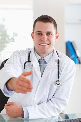 Smiling doctor extending his hand