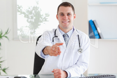 Smiling doctor welcoming his patient