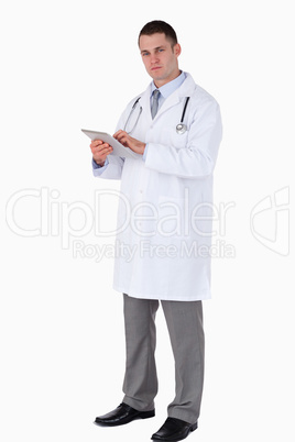 Serious looking doctor with his tablet