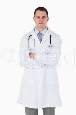 Serious looking doctor with arms folded