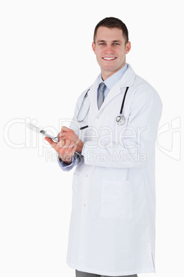 Smiling doctor taking notes