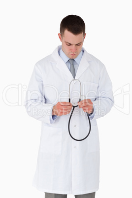 Doctor looking at his stethoscope