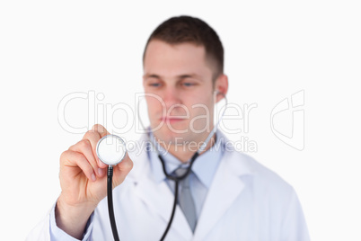 Close up of doctor looking at this stethoscope