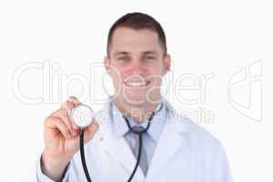 Close up of smiling doctor using his stethoscope
