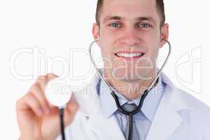 Close up of smiling doctor using stethoscope