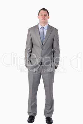 Smiling businessman with hands in his pocket