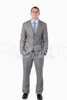 Smiling businessman with hands in his pocket