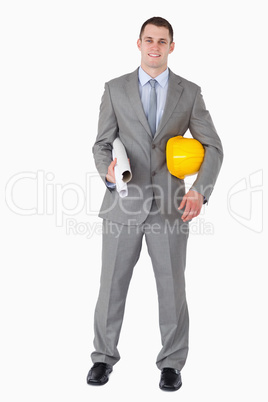 Smiling architect with helm and plans