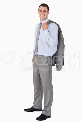 Smiling businessman with his coat tossed over his shoulder