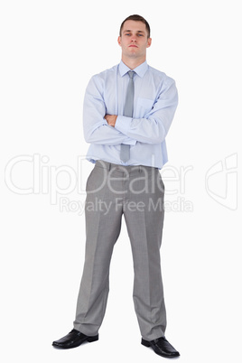 Serious looking businessman with his arms folded