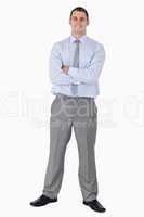 Happy businessman with his arms folded