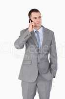 Close up of businessman on the cellphone in thoughts