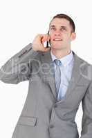 Close up of businessman on the phone looking up