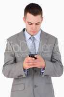Close up of young businessman writing text message
