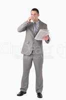 Portrait of a businessman holding a newspaper while drinking cof