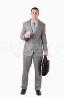 Portrait of a businessman holding a cup of coffee and a computer