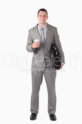Portrait of a businessman holding a cup of tea and a computer ba