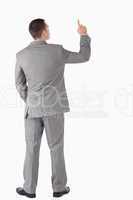 Portrait of a young businessman pointing at something