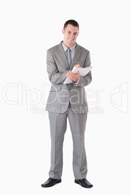 Portrait of a smiling businessman taking notes