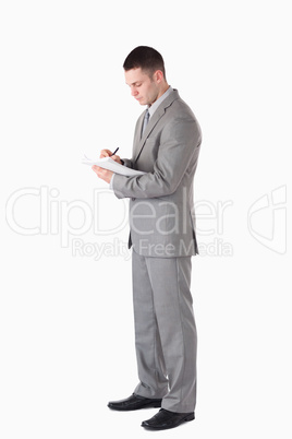 Portrait of a serious businessman taking notes