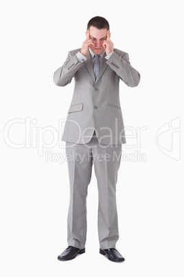 Portrait of a young businessman having a headache