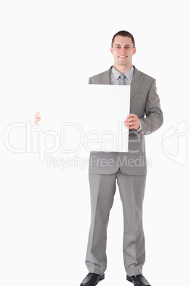 Portrait of a smiling businessman showing a blank panel