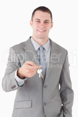 Portrait of a young businessman showing a set of keys
