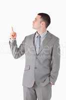 Portrait of a handsome businessman pointing at something