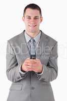 Portrait of a businessman holding his cellphone