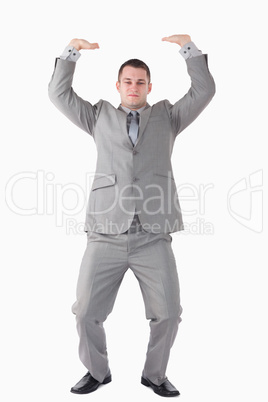 Portrait of a businessman pushing the roof