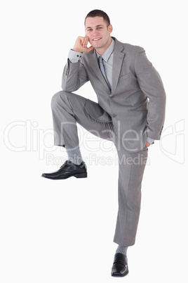 Portrait of a businessman with his foot on something