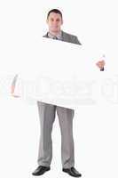Portrait of a businessman holding a blank panel