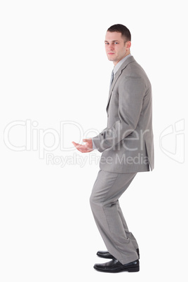 Portrait of a young businessman carrying something